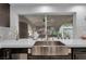 Kitchen showcasing modern stainless steel farmhouse sink with a backyard view at 4108 Royal Scots Ave, Las Vegas, NV 89141