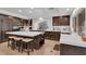 Spacious kitchen featuring a large center island, stainless steel sink, and dark wood cabinets at 4108 Royal Scots Ave, Las Vegas, NV 89141