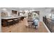Open kitchen and dining area featuring seating at the island and modern lighting at 4108 Royal Scots Ave, Las Vegas, NV 89141