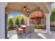 Cozy outdoor dining area next to a custom-built treehouse and manicured landscaping at 4108 Royal Scots Ave, Las Vegas, NV 89141