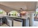 Outdoor kitchen features granite countertops, stainless steel fridge, and covered patio at 4108 Royal Scots Ave, Las Vegas, NV 89141