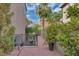 Serene outdoor patio surrounded by lush landscaping and mature palm trees, providing a private retreat at 4108 Royal Scots Ave, Las Vegas, NV 89141