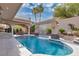 Beautiful backyard pool with rock waterfall feature, lush landscaping, and inviting ambiance at 4108 Royal Scots Ave, Las Vegas, NV 89141