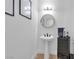 Modern powder room featuring updated vanity, faucet, and mirror at 4108 Royal Scots Ave, Las Vegas, NV 89141