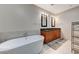 Modern bathroom featuring a soaking tub and double vanity with dark countertops at 4525 Dean Martin Dr # 1208, Las Vegas, NV 89103