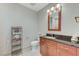 Cozy bathroom with dark wood vanity, granite countertop, and decorative mirror at 4525 Dean Martin Dr # 1208, Las Vegas, NV 89103