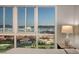 Bedroom showcasing expansive windows with cityscape views and bedside table at 4525 Dean Martin Dr # 1208, Las Vegas, NV 89103