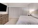 Serene bedroom featuring a neutral color palette, soft carpet, and a dresser at 4525 Dean Martin Dr # 1208, Las Vegas, NV 89103