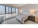 Bedroom featuring city views from expansive windows, a cozy bed, and stylish nightstands at 4525 Dean Martin Dr # 1208, Las Vegas, NV 89103