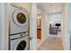 Hallway featuring a stacked washer and dryer with access to a full bathroom and living area at 4525 Dean Martin Dr # 1208, Las Vegas, NV 89103