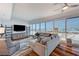Bright living room featuring hardwood floors, large windows, and comfortable seating at 4525 Dean Martin Dr # 1208, Las Vegas, NV 89103