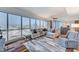 Bright living room with hardwood floors, large windows, and comfortable seating at 4525 Dean Martin Dr # 1208, Las Vegas, NV 89103