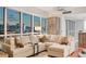 Spacious living room with hardwood floors, large windows, and comfortable sectional couch at 4525 Dean Martin Dr # 1208, Las Vegas, NV 89103