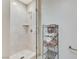 Modern shower with glass door and niche, alongside a towel rack with neatly stacked towels at 4525 Dean Martin Dr # 1208, Las Vegas, NV 89103