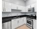Modern kitchen featuring white cabinets, stainless steel appliances, and black countertops at 4575 Dean Martin Dr # 304, Las Vegas, NV 89103