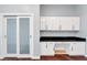 Bright office space with white cabinets, black countertop, and hardwood floors at 4575 Dean Martin Dr # 304, Las Vegas, NV 89103