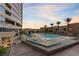Enjoy the community pool with lounge seating, palm trees, and views of the city skyline at 4575 Dean Martin Dr # 304, Las Vegas, NV 89103