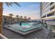 Enjoy the community pool, palm trees, and lounge chairs with high-rise in the background at 4575 Dean Martin Dr # 304, Las Vegas, NV 89103