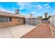 Large backyard featuring an enclosed patio, gravel landscaping, and solar panels at 4719 Sparta Way, North Las Vegas, NV 89032