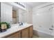 Well-lit bathroom with vanity, sink and bathtub shower at 4719 Sparta Way, North Las Vegas, NV 89032