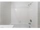 Bright bathroom bathtub and shower featuring clean, white tiling at 4719 Sparta Way, North Las Vegas, NV 89032