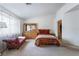 Bright bedroom with light, featuring a full dresser and comfortable chaise lounge at 4719 Sparta Way, North Las Vegas, NV 89032