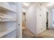Bright hallway with an open linen closet and a peek into the laundry room at 4719 Sparta Way, North Las Vegas, NV 89032