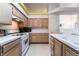 Bright kitchen with wooden cabinets, white appliances, and plenty of countertop space at 4719 Sparta Way, North Las Vegas, NV 89032