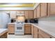 A kitchen with wood cabinets, modern appliances, and tile countertops, offering ample cooking space at 4719 Sparta Way, North Las Vegas, NV 89032