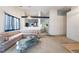 Open-concept living room with a large sofa, glass coffee table, and inviting atmosphere at 4719 Sparta Way, North Las Vegas, NV 89032