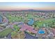 Aerial view of community featuring mature landscaping, community pool, golf course, and scenic mountain backdrop at 5429 Sweet Shade St, Las Vegas, NV 89130