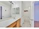 Bathroom with large mirror, wood cabinets, single sink, and separate shower and toilet area at 5429 Sweet Shade St, Las Vegas, NV 89130
