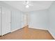 Bedroom with wood floors and ceiling fan; view to bathroom and closet at 5429 Sweet Shade St, Las Vegas, NV 89130