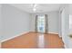 Bedroom with wood floors, a ceiling fan, and a large window with natural light at 5429 Sweet Shade St, Las Vegas, NV 89130