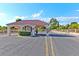 View of the community entrance featuring a red tile roof and neat landscaping at 5429 Sweet Shade St, Las Vegas, NV 89130