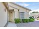 Inviting home entrance features a well-lit porch, manicured shrubs, and a tiled roof at 5429 Sweet Shade St, Las Vegas, NV 89130