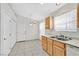 Kitchen features tile floors, white appliances, and light wood cabinets with easy access to the door at 5429 Sweet Shade St, Las Vegas, NV 89130