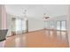 Open living room with wood floors, vaulted ceiling, chandelier, and large windows offering ample natural light at 5429 Sweet Shade St, Las Vegas, NV 89130