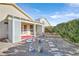 Backyard with covered patio, small bird bath, stone pavers, and desert landscaping at 5429 Sweet Shade St, Las Vegas, NV 89130