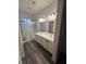 Bathroom featuring double sinks, luxury vinyl floors and a glass enclosed shower at 5591 La Perla Ct, Las Vegas, NV 89122