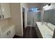Bathroom featuring double sinks, luxury vinyl floors and a glass enclosed shower at 5591 La Perla Ct, Las Vegas, NV 89122