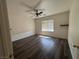Bedroom featuring wood flooring, fan, and natural light at 5591 La Perla Ct, Las Vegas, NV 89122