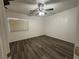 Bedroom featuring wood flooring, fan, and natural light at 5591 La Perla Ct, Las Vegas, NV 89122