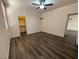 Comfortable bedroom featuring dark floors, ceiling fan, closet, and ample natural light at 5591 La Perla Ct, Las Vegas, NV 89122