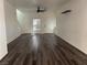 Inviting living area featuring dark flooring, neutral walls, and ample natural light from the front door at 5591 La Perla Ct, Las Vegas, NV 89122