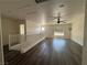 Spacious living room featuring wood floors, fan, and ample natural light at 5591 La Perla Ct, Las Vegas, NV 89122