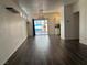 Spacious living room with modern dark flooring and sliding door to outdoor space at 5591 La Perla Ct, Las Vegas, NV 89122