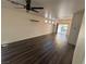 Bright living room features dark wood-look floors and abundant natural light from the sliding glass door at 5591 La Perla Ct, Las Vegas, NV 89122