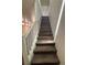 Staircase featuring dark wood-look steps and white railings leading to the upper level at 5591 La Perla Ct, Las Vegas, NV 89122
