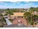 Expansive property with a circular driveway, lush landscaping, and mountain views at 5829 W Patrick Ln, Las Vegas, NV 89118